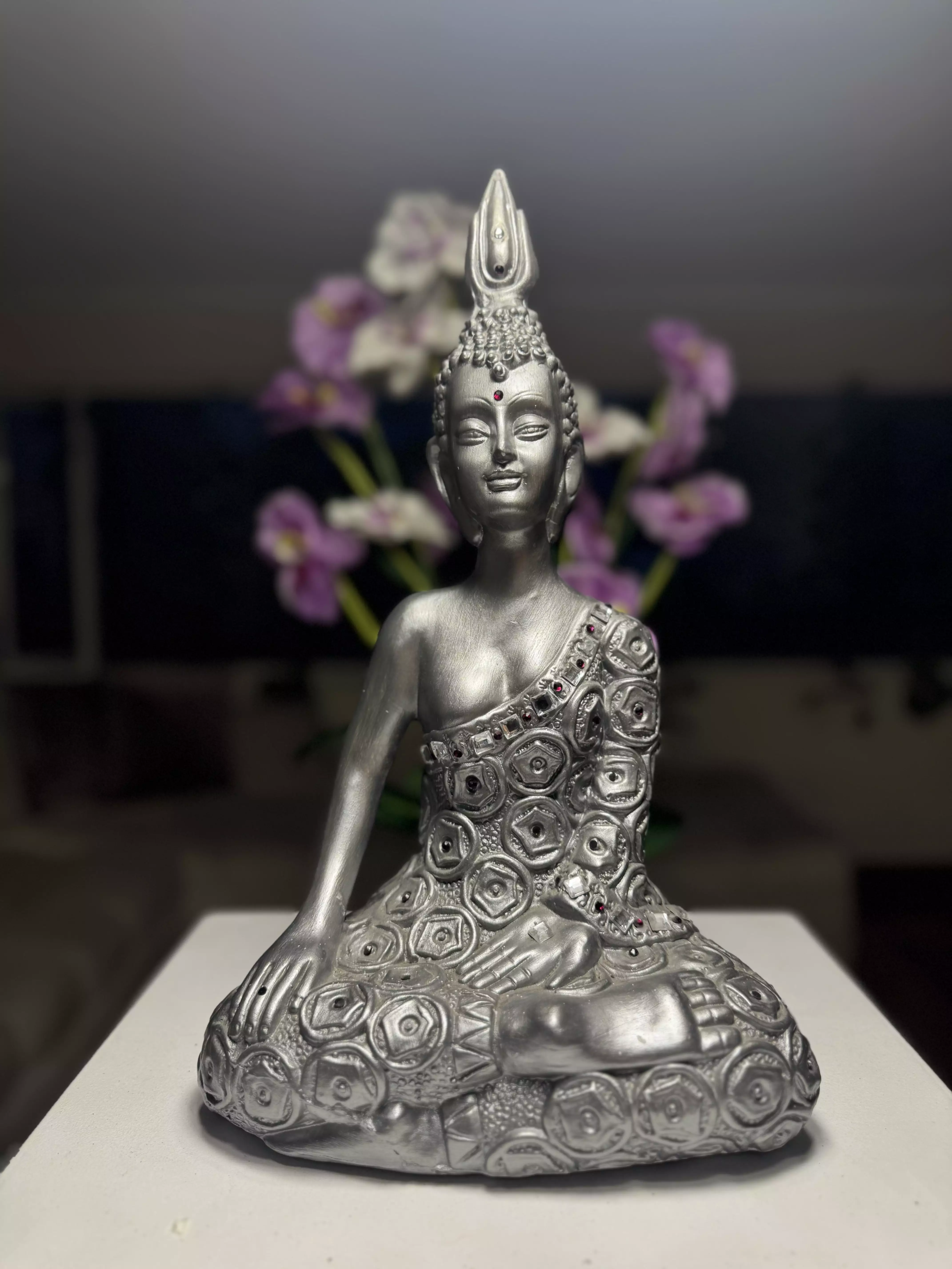 Buddha with flower arrangement